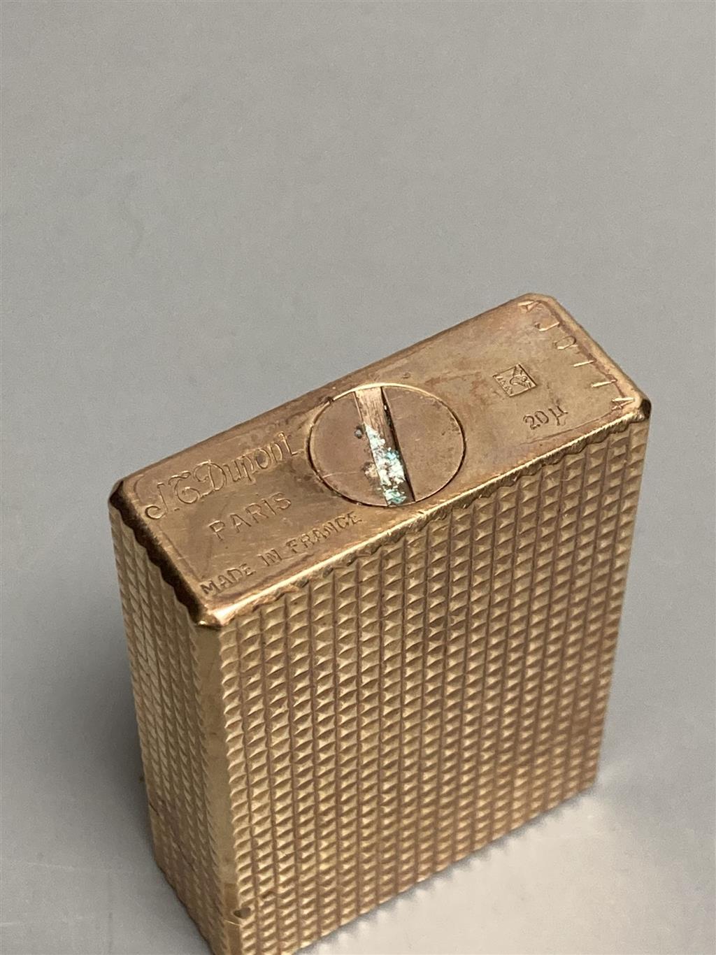 An S. T. Dupont, Paris gold-plated cigarette lighter (20 mu), original box and two white metal chain-link necklaces